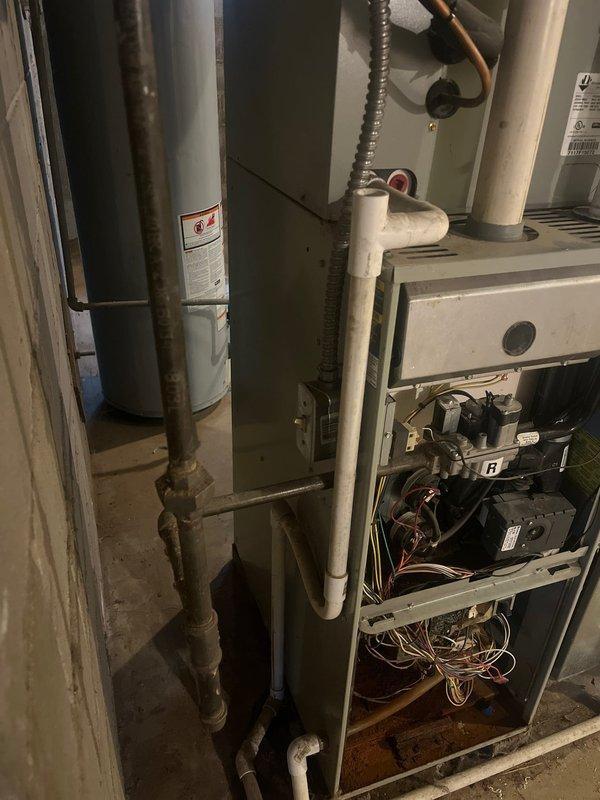 Inspected red-tagged furnace in home currently being prepared for sale. Documented significant corrosion on copper connections and deteriorated internal components including compromised circuit boards and wiring harnesses. Recommended complete furnace replacement to restore system safety and functionality for property transfer requirements.