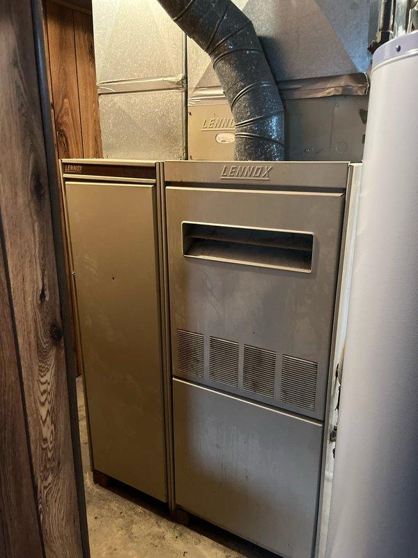 # HVAC Estimate - Replacement Summary

Conducted furnace replacement estimate for existing Lennox system installed in basement utility room. Assessed current equipment configuration including furnace unit and air handler, evaluated ductwork connections and clearances, and documented system specifications. Customer expressed interest in retrofit options with cost-effectiveness as primary consideration factor.

# Detailed Job Description

Performed comprehensive estimate assessment for furnace replacement in residential basement mechanical room. Evaluated existing Lennox HVAC system consisting of furnace unit and adjacent air handler cabinet currently installed against concrete block wall. 

Documented current system configuration including flexible black ductwork connections at supply plenum, metal trunk line distribution through exposed ceiling joists, and clearance spacing relative to adjacent water heater equipment. Assessed accessibility for replacement installation considering conc