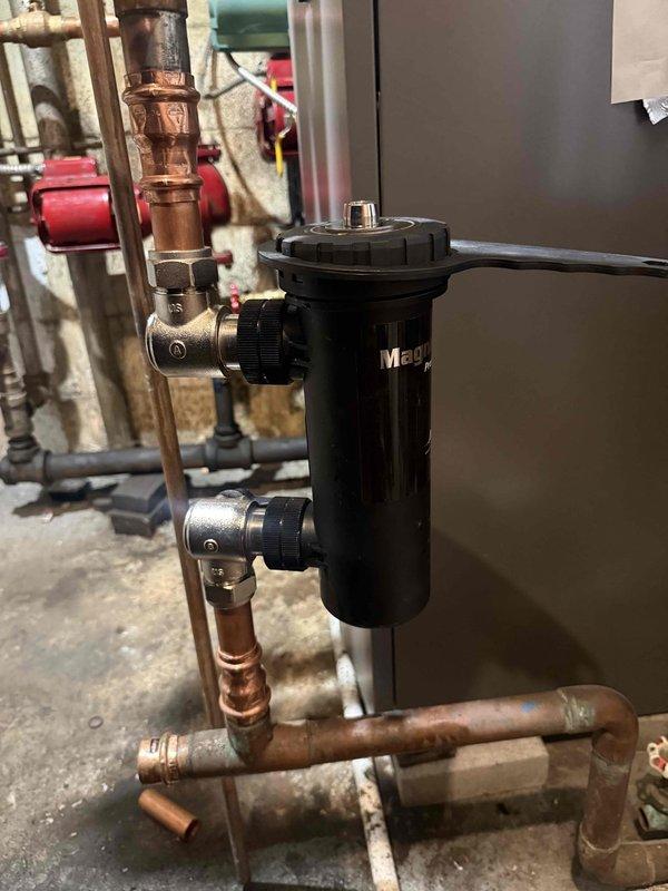 Installed iMag dirt separator on the heating system to remove debris and sediment from the circulating water. Integrated the unit into existing copper piping using appropriate brass fittings and isolation valves to allow for future maintenance. Flushed and cleaned the entire hydronic system to remove accumulated particulates and improve system efficiency and component longevity.