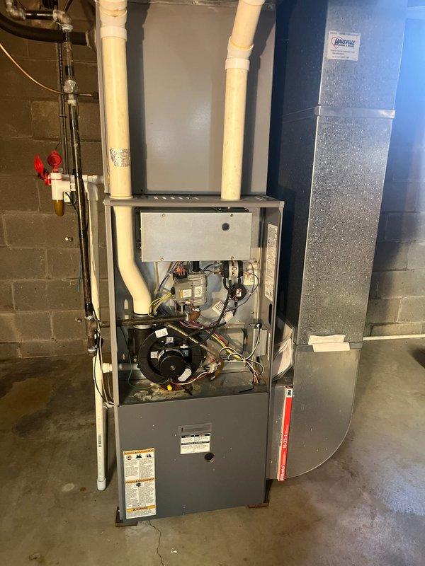 Conducted HVAC system evaluation and provided replacement estimate for residential gas furnace with confirmed cracked heat exchanger. Unit was photographed showing open access panels with internal components exposed, including blower assembly, gas valve, electrical connections, and heat exchanger assembly. Despite the compromised heat exchanger—a critical safety concern that can allow carbon monoxide infiltration into living spaces—the furnace was still operational at time of inspection. Documented existing installation including white PVC intake and exhaust venting, gas line connections with shutoff valves, electrical service, and associated ductwork connections. Presented comprehensive replacement options to address the failed heat exchanger and ensure safe, efficient heating system operation.