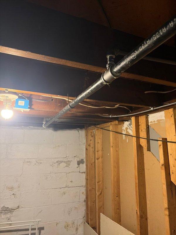 Completed installation of gas line infrastructure serving new furnace and hot water heater system. Installed exterior PVC vent piping through building envelope with proper termination and drainage provisions, and routed metallic flexible ductwork through basement ceiling joists to distribute conditioned air throughout the structure. All work performed to code specifications with secure mounting and proper clearances maintained.