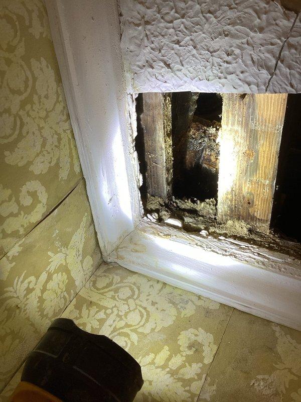 Responded to water leak complaint and performed investigative opening of bathroom ceiling to locate source of water intrusion. Removed section of ceiling drywall at wall-ceiling junction to expose plumbing lines and structural framing. Investigation revealed evidence of active water damage with visible mold growth and deterioration on wooden framing members. Documented existing conditions with photographs showing compromised building materials, water staining, and structural exposure. Provided estimate for necessary repairs including water damage remediation, mold treatment, and ceiling restoration work.