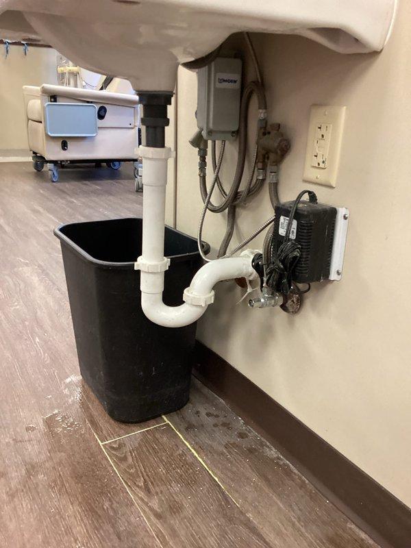 Responded to bathroom sink leak complaint and performed thorough inspection of plumbing system. Upon examination, documented existing plumbing configuration including P-trap assembly, supply line connections, and shut-off valves. Noted visible water damage on flooring near base of wall indicating active or recent leak. Inspected all flexible braided supply lines, compression fittings, and drain connections for signs of moisture or failure points.