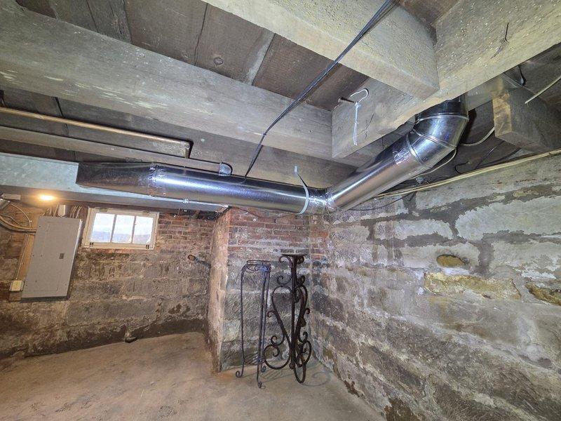 Replaced HVAC ductwork in basement and attic areas where original sections were removed during asbestos abatement. Installed new metallic ductwork with proper transitions, elbows, and sealed connections throughout exposed ceiling joists in basement space and integrated new vertical duct runs through upper structural cavities. All ductwork was properly secured to existing framing, sealed at joints with foil tape, and routed to maintain efficient airflow while working around existing plumbing, electrical conduit, and building infrastructure.