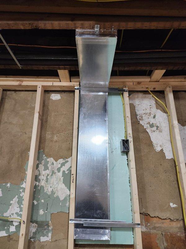Completed rerun of range hood ventilation ductwork for new construction callback. Installed new galvanized metal ductwork from interior ceiling space through roof penetration, ensuring proper routing and support. Terminated vent stack on roof surface with appropriate elbow configuration and rain cap, secured with professional flashing and weatherproofing at penetration point to prevent water infiltration.