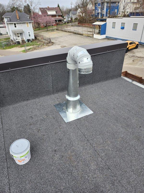 Completed rerun of range hood ventilation ductwork for new construction callback. Installed new galvanized metal ductwork from interior ceiling space through roof penetration, ensuring proper routing and support. Terminated vent stack on roof surface with appropriate elbow configuration and rain cap, secured with professional flashing and weatherproofing at penetration point to prevent water infiltration.