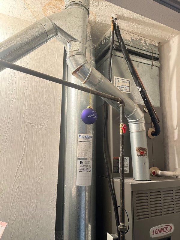 Completed furnace replacement with new Lennox unit installed in residential utility space. System properly positioned, connected to existing ductwork, and vented according to manufacturer specifications with all electrical and gas connections secured and tested for safe operation.