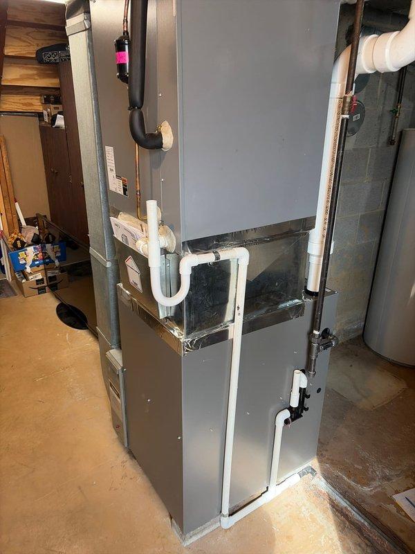 Completed full furnace replacement with new Lennox high-efficiency unit installed in basement utility area. Installed new chimney liner system to properly vent combustion gases. Configured PVC condensate drainage and venting system with multiple elbows routed vertically and horizontally for proper water removal and air intake/exhaust. Connected all ductwork including black flexible supply ducts and white corrugated venting pipes. Verified all electrical connections, tested furnace operation with green indicator light confirming proper system startup, and ensured all manufacturer specifications were met per unit compliance plate.