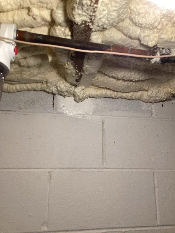 Responded to water leak at whole house water filter system in 1971-built residence. Upon inspection, identified small leak at filter housing connection point. Repaired leak by tightening housing assembly and replacing O-ring seal to restore proper water-tight integrity. System tested and verified no further leakage present. Filter assembly located in basement utility area with PVC supply lines running along foundation wall.