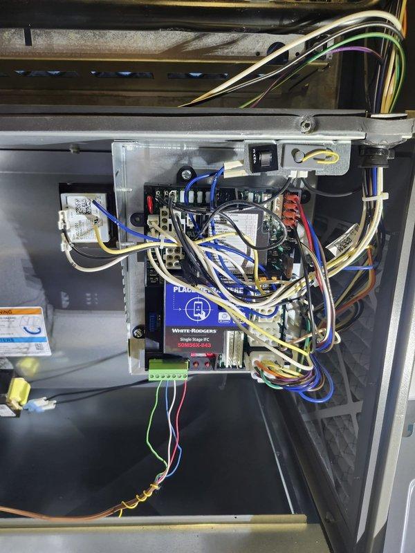 Responded to no heat call on newly installed furnace in pavilion. Upon arrival, found thermostat displaying 53°F and not calling for heat. Inspected furnace control board and electrical connections, verified all wiring terminations at White-Rodgers control module and terminal strips were secure. Cycled thermostat to initiate heat call, confirmed proper communication between thermostat and furnace control board. System now operating normally and providing heat to space.
