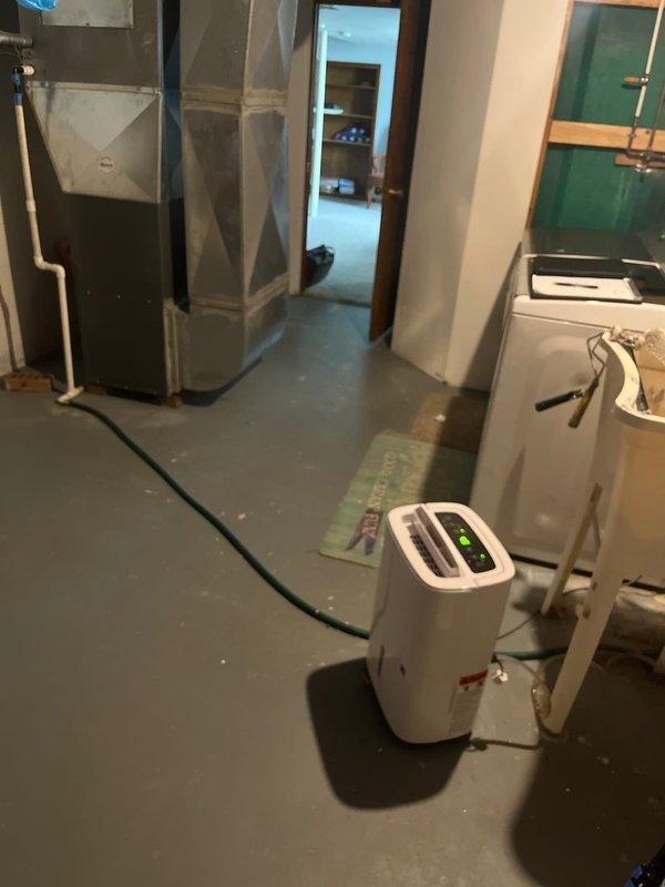 Completed furnace and air conditioning system retrofit in residential basement utility area. Removed existing HVAC equipment and installed new heating and cooling system with updated ductwork connections, ensuring proper integration with existing infrastructure including water heater and electrical systems. All equipment tested and operational upon completion.