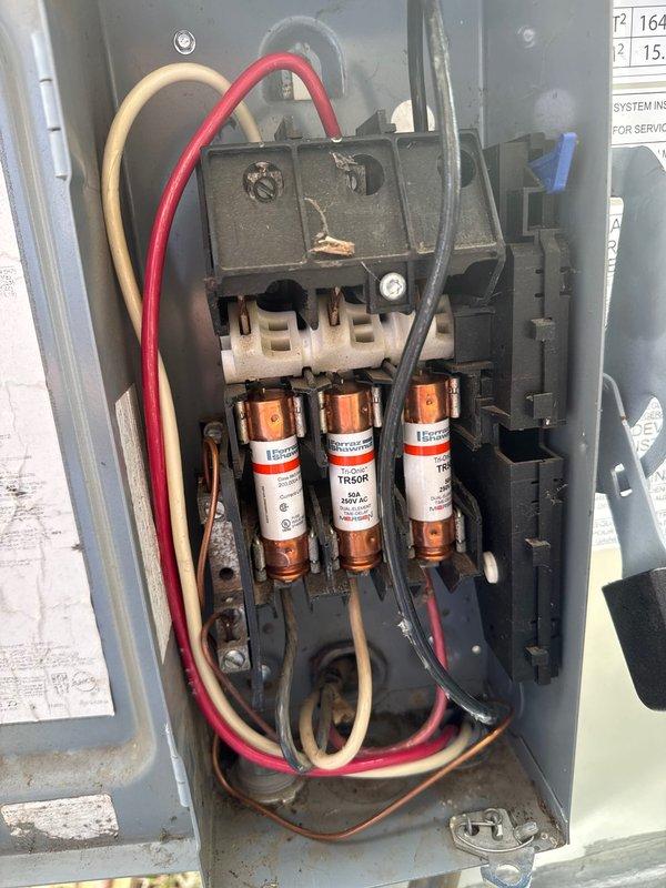 Successfully installed a Daikin 7.5-ton rooftop package unit for a commercial new construction project. The unit was positioned on a concrete pad at ground level adjacent to the building, with metallic ductwork connected vertically to the structure. Electrical disconnect box was wired and equipped with TR60R 600V AC fuses, ensuring proper overcurrent protection and safe disconnect capability for the equipment.