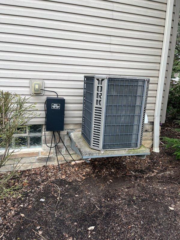 Completed full HVAC system replacement including installation of new York furnace in basement utility room and matching York condenser unit on exterior concrete pad. Installed PVC intake and exhaust venting from furnace through ceiling, ran copper refrigerant lines with insulation connecting indoor and outdoor units, and mounted electrical disconnect box with conduit routing to house electrical system. All ductwork connections, electrical wiring, and control systems properly configured and tested for operation.