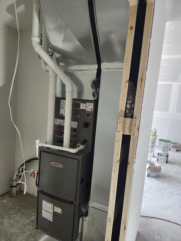 Completed new construction HVAC installation featuring a Lennox furnace system in a residential mechanical room. Installed and positioned furnace unit, connected black flexible ductwork, routed white PVC venting system with proper elbows and transitions, and integrated electrical connections to the breaker panel. Installed supply and return ductwork including four 14x6 registers, five 4x14 registers, and three 4x10 registers as specified for proper air distribution throughout the structure.