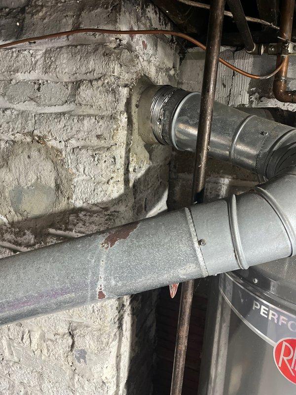 Completed full HVAC system retrofit including furnace and air conditioning unit replacement. Installed new Rheem outdoor condensing unit on existing concrete pad with proper gravel drainage, established electrical disconnect and conduit connections to exterior wall, and integrated new ductwork sections within basement utility area using metallic duct transitions connected to existing infrastructure. All refrigerant lines, electrical wiring, and mechanical connections were properly secured and tested for system operation.