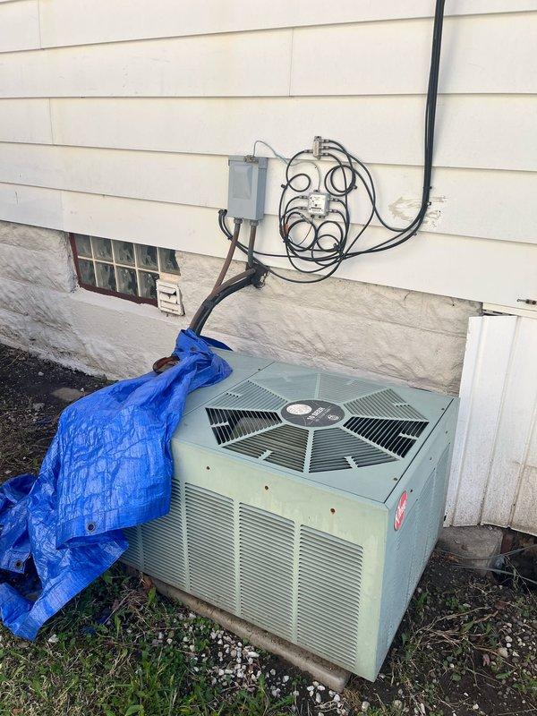 Completed full HVAC system retrofit including furnace and air conditioning unit replacement. Installed new Rheem outdoor condensing unit on existing concrete pad with proper gravel drainage, established electrical disconnect and conduit connections to exterior wall, and integrated new ductwork sections within basement utility area using metallic duct transitions connected to existing infrastructure. All refrigerant lines, electrical wiring, and mechanical connections were properly secured and tested for system operation.