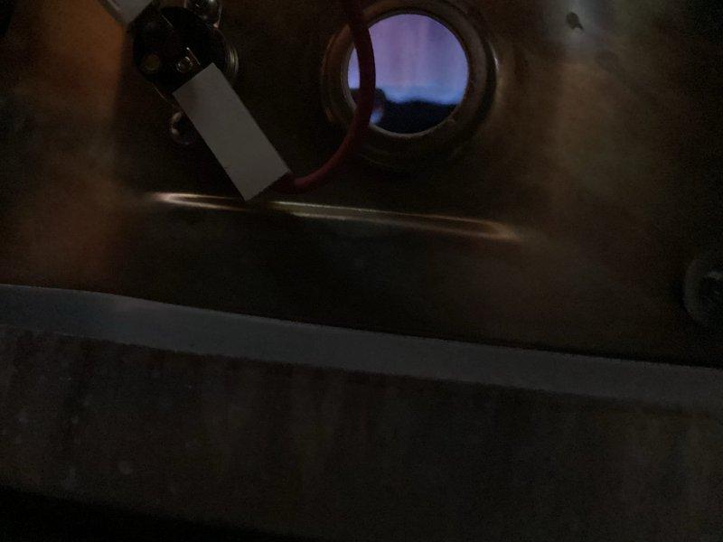 Responded to callback for persistent leak issue. Upon arrival, inspected water heater and associated piping system. Examined temperature and pressure relief valve, copper supply lines, and PVC drain connections. Photographed temperature gauge reading on copper pipe showing system operating temperature between 110-140 degrees. Inspected internal components through access port, noting condition of heating elements, sensors, and electrical connections. Identified source of continued leak at connection point. Tightened fittings, replaced faulty gasket, and tested system under pressure to verify repair completed successfully with no further leakage detected.