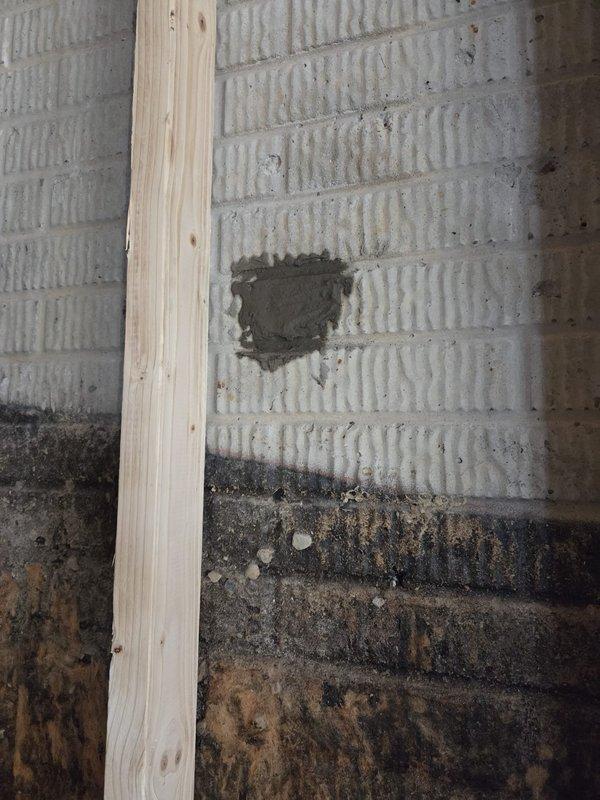 Conducted site assessment for new construction ductwork installation in addition area. Documented existing conditions including interior wall framing, concrete block foundation walls, and structural elements to determine optimal routing for HVAC distribution system. Identified areas requiring coordination with existing building envelope and noted moisture-affected zones in lower wall sections that will need remediation prior to duct installation and insulation work.