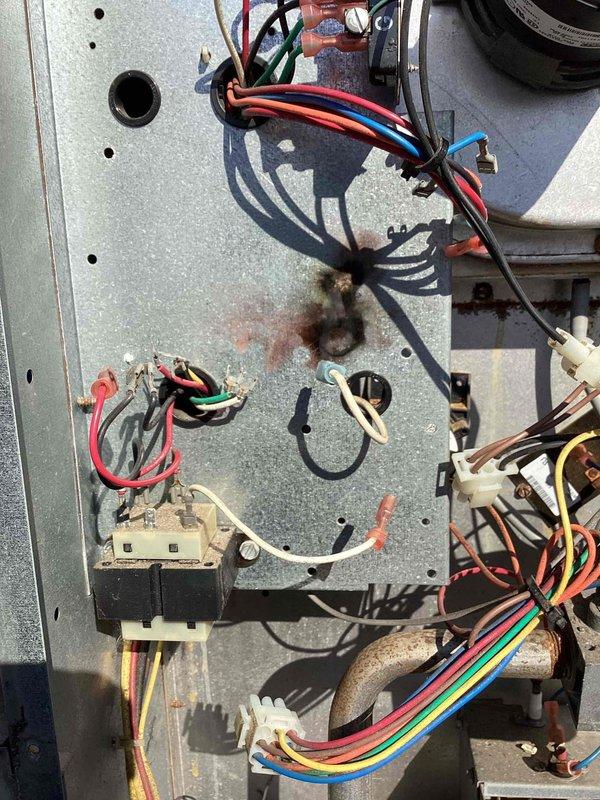 Responded to callback for infant room heating issue with temperature at 55 degrees. Upon inspection, found flame sensor heavily soiled with rust and debris accumulation preventing proper burner operation. Cleaned flame sensor and burner assembly, addressed corrosion on control panel components, and verified system restored to proper heating function.