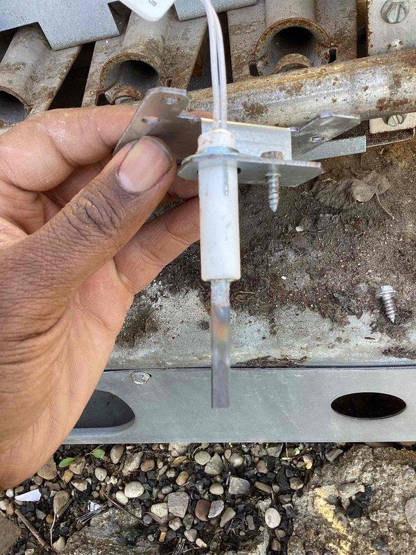 Responded to callback for infant room heating issue with temperature at 55 degrees. Upon inspection, found flame sensor heavily soiled with rust and debris accumulation preventing proper burner operation. Cleaned flame sensor and burner assembly, addressed corrosion on control panel components, and verified system restored to proper heating function.