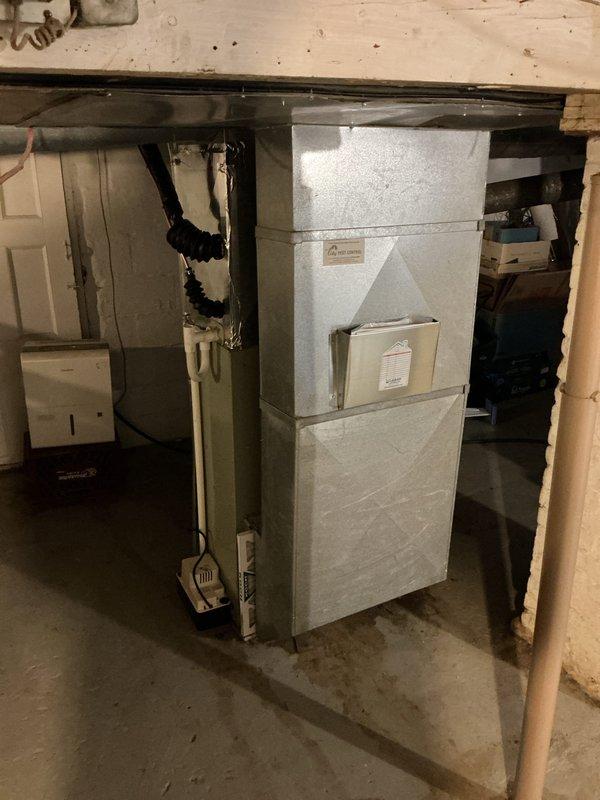 Completed installation of add-on air conditioning system to existing heating infrastructure. Installed indoor air handler unit in basement utility space with proper condensate management and integrated ductwork connections to overhead distribution system. Mounted outdoor condensing unit on level platform adjacent to building foundation, established refrigerant line set through exterior wall with appropriate insulation and securing brackets, and installed electrical disconnect box per code requirements.