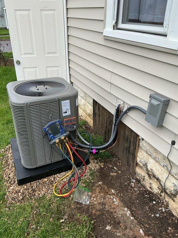 Completed installation of add-on air conditioning system to existing heating infrastructure. Installed indoor air handler unit in basement utility space with proper condensate management and integrated ductwork connections to overhead distribution system. Mounted outdoor condensing unit on level platform adjacent to building foundation, established refrigerant line set through exterior wall with appropriate insulation and securing brackets, and installed electrical disconnect box per code requirements.