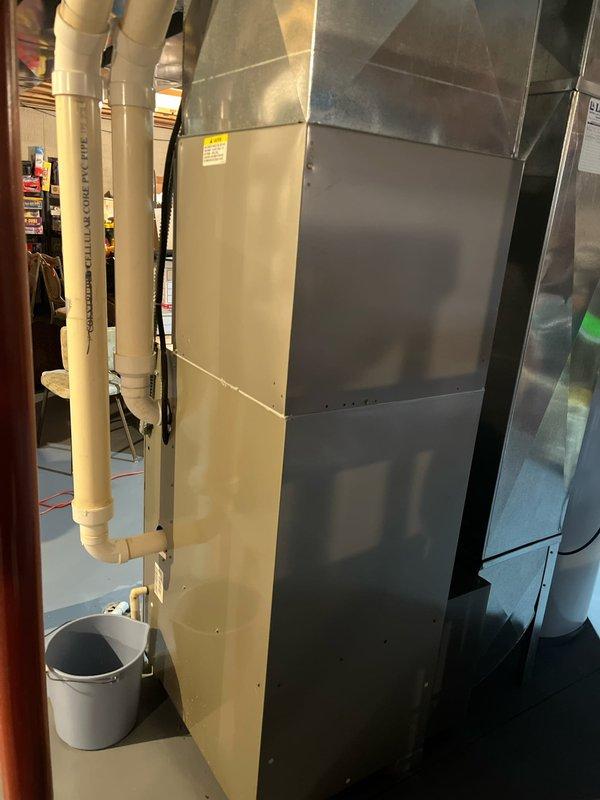 Completed residential AC replacement in garage utility area. Installed new Carrier furnace system with properly configured metallic ductwork, flexible ducting with protective wrapping, and white PVC condensate drainage lines. Connected electrical components to existing breaker panel, ensured proper routing of all ductwork and piping per HVAC standards, and verified system installation on concrete pad with adequate clearances for service access.