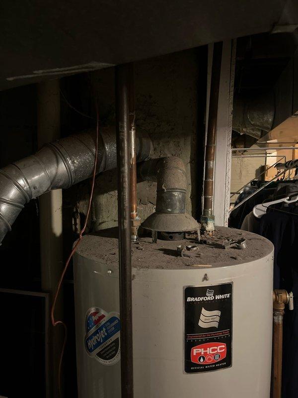 Completed site assessment for AC add-on installation in residential basement utility area. Documented existing HVAC infrastructure including furnace unit, ductwork configuration, and water heater placement to determine optimal integration points for new air conditioning system and evaluate spatial requirements for equipment installation.