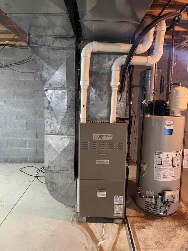 Completed full HVAC system assessment for replacement in residential basement mechanical room. Documented existing Armstrong Ultra V furnace, water heater, ductwork configuration, and associated PVC venting system showing signs of age and wear, including discolored metal ductwork. Provided comprehensive estimate for complete system replacement to address customer's request for expedited full system upgrade.