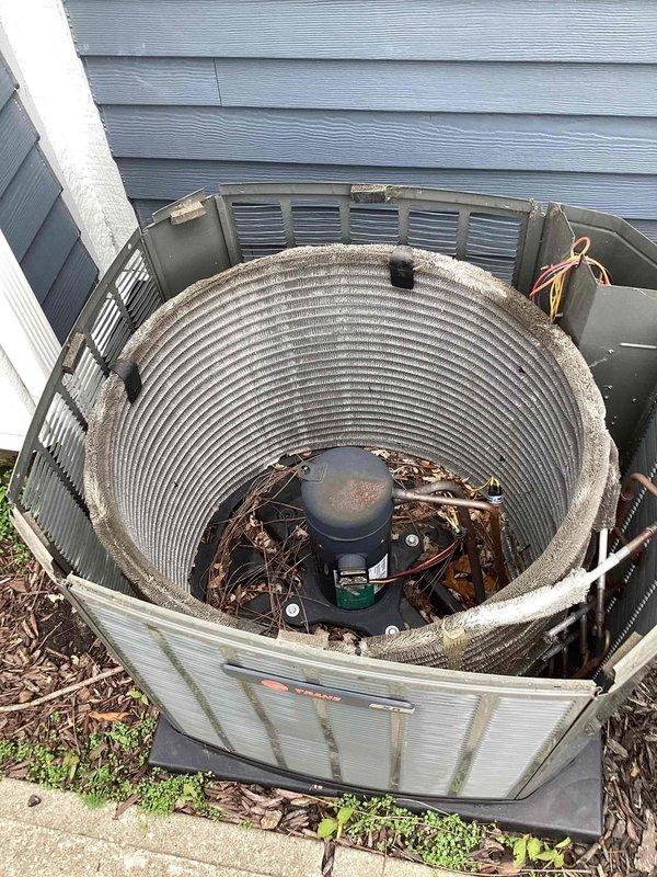 Performed comprehensive clean and check service on commercial air conditioning condenser unit. Upon arrival, contacted customer as requested before beginning work. Removed protective grille cover to access internal components and conducted thorough inspection. Cleaned condenser coil which showed significant accumulation of dirt, debris, and weathering with grayish-brown discoloration. Removed brown leaves and organic debris that had accumulated inside unit and between components. Inspected compressor, refrigerant lines, and electrical connections, noting oxidation and wear consistent with outdoor exposure and extended service period. Verified all mechanical components were functioning properly. Reinstalled protective grille cover and restored unit to operational status. Provided customer with replacement filters as requested.