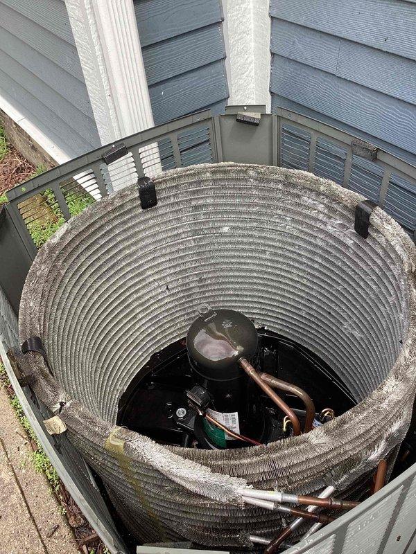 Performed comprehensive clean and check service on commercial air conditioning condenser unit. Upon arrival, contacted customer as requested before beginning work. Removed protective grille cover to access internal components and conducted thorough inspection. Cleaned condenser coil which showed significant accumulation of dirt, debris, and weathering with grayish-brown discoloration. Removed brown leaves and organic debris that had accumulated inside unit and between components. Inspected compressor, refrigerant lines, and electrical connections, noting oxidation and wear consistent with outdoor exposure and extended service period. Verified all mechanical components were functioning properly. Reinstalled protective grille cover and restored unit to operational status. Provided customer with replacement filters as requested.