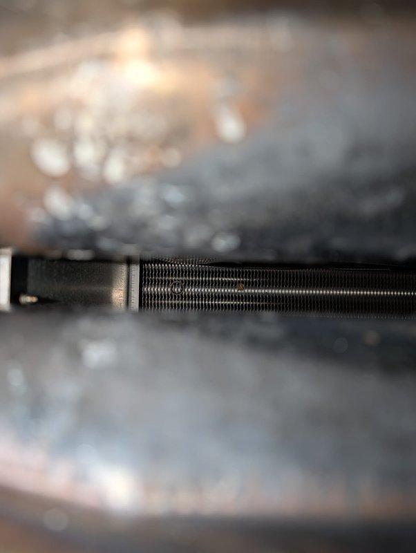 Completed full AC retrofit installation featuring a new Lennox outdoor condensing unit with matching evaporator coil system. Unit was positioned on concrete pad with river rock landscaping, electrical disconnect and line set connections properly installed and secured to building exterior per manufacturer specifications. All refrigerant lines, condensate drainage, and electrical wiring terminated according to code requirements, system tested and verified operational.