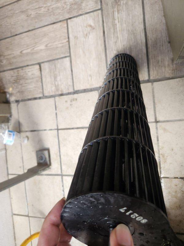 Performed routine commercial cooling maintenance on Mitsubishi wall-mounted air conditioning unit. Removed and inspected blower wheel assembly, which showed dirt and moisture accumulation on the squirrel cage fan blades. Cleaned blower wheel component to restore proper airflow and system efficiency. Verified unit operation and confirmed proper functionality of the indoor air handler upon completion of maintenance procedures.