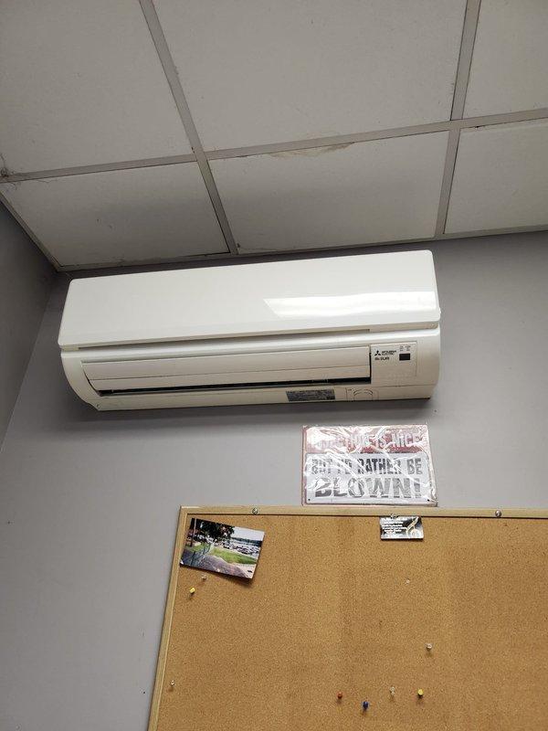 Performed routine commercial cooling maintenance on Mitsubishi wall-mounted air conditioning unit. Removed and inspected blower wheel assembly, which showed dirt and moisture accumulation on the squirrel cage fan blades. Cleaned blower wheel component to restore proper airflow and system efficiency. Verified unit operation and confirmed proper functionality of the indoor air handler upon completion of maintenance procedures.