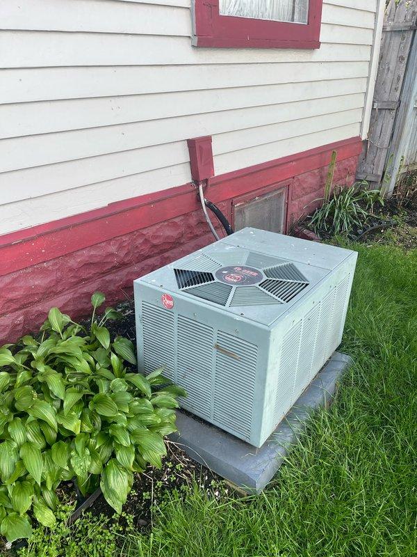 Performed comprehensive assessment of existing HVAC system including outdoor Rheem air conditioning condenser unit and indoor furnace located in basement mechanical room. Evaluated both units for replacement, documented current equipment condition and installation configuration, and provided detailed estimate for complete system replacement of both heating and cooling components.