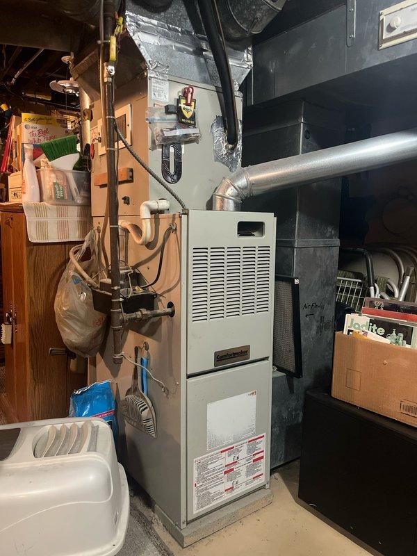 Performed comprehensive assessment of existing HVAC system including outdoor Rheem air conditioning condenser unit and indoor furnace located in basement mechanical room. Evaluated both units for replacement, documented current equipment condition and installation configuration, and provided detailed estimate for complete system replacement of both heating and cooling components.