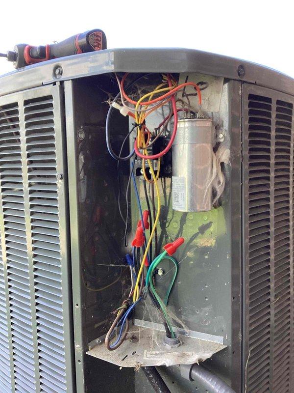 Completed scheduled commercial cooling maintenance visit on outdoor condensing unit. Performed comprehensive system inspection with access panel and top cover removal to evaluate internal components, electrical connections, and coil conditions. Inspected compressor, capacitor, refrigerant lines, and wiring harness for proper operation and wear. Coils showed good condition with clean fins; noted minor dirt accumulation in base pan and copper line oxidation consistent with normal outdoor exposure. All electrical connections secure with proper wire management observed. Unit operating within normal parameters. Documented system condition with photographs for service records.
