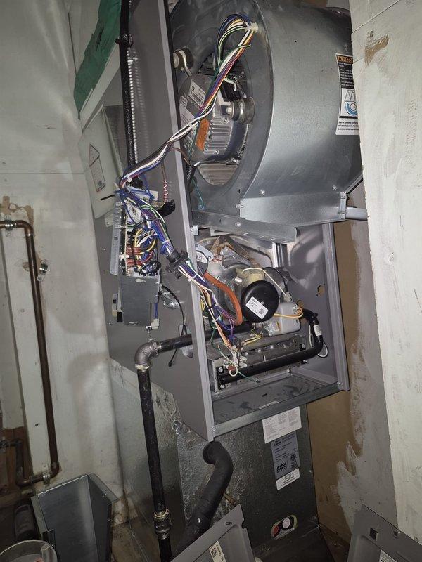 Responded to no heat call with thermostat reading 62°F and non-operational blower motor. Upon inspection, accessed furnace cabinet and diagnosed blower assembly failure. Verified unit is under manufacturer warranty and documented internal components including blower housing, electrical connections, and control board for warranty claim processing.