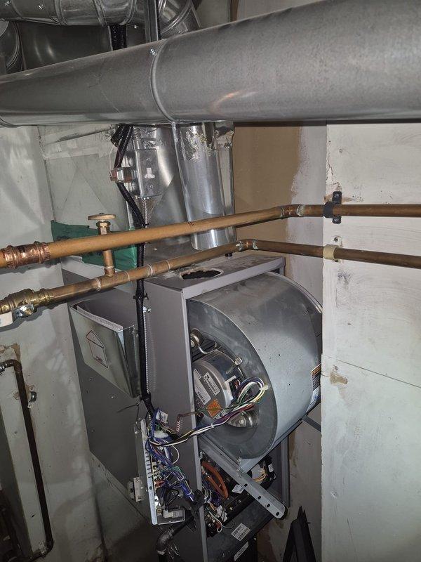 Responded to no heat call with thermostat reading 62°F and non-operational blower motor. Upon inspection, accessed furnace cabinet and diagnosed blower assembly failure. Verified unit is under manufacturer warranty and documented internal components including blower housing, electrical connections, and control board for warranty claim processing.