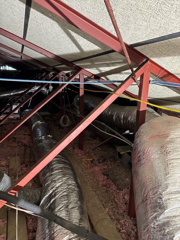 Installed additional return air filter grill in attic space to improve HVAC system airflow distribution. Modified existing ductwork by adding tee connection in ceiling plenum, integrating new return pathway with current system configuration. Work completed in commercial new construction warranty service, ensuring proper airflow balance and system performance per design specifications.
