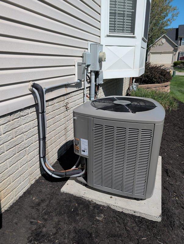 # HVAC Install - Complete System

Completed full HVAC system installation at residential property. Installed new outdoor condensing unit on concrete pad against exterior wall with proper clearances maintained. Unit positioned on level foundation pad with appropriate drainage considerations.

Routed refrigerant line set from outdoor unit up exterior wall to interior air handler connection point. Lines properly insulated with black foam insulation to prevent condensation and energy loss. Secured refrigerant piping with appropriate fasteners and maintained professional appearance along building exterior.

Installed electrical disconnect box on exterior wall per code requirements, positioned for safe and convenient access. Completed all electrical connections from disconnect to condensing unit following manufacturer specifications and local electrical codes.

Brazed refrigerant line connections at outdoor unit using proper techniques to ensure leak-free joints. Performed nitrogen purge dur