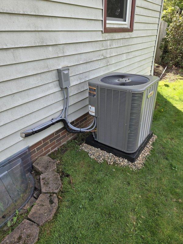 Completed HVAC rough-in ductwork installation for residential renovation project. Installed main trunk line and branch ducts through framed chase opening, including flexible duct connections to distribution points. Exterior condensing unit previously positioned on gravel pad with proper electrical disconnect and conduit routing in place.