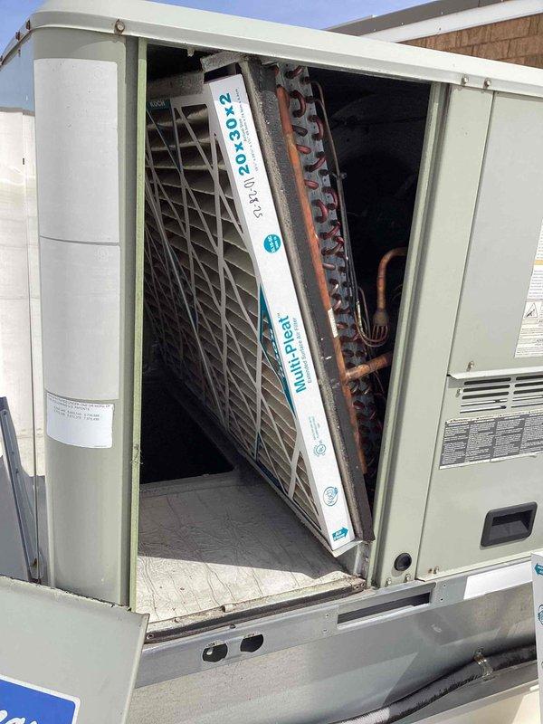 Completed scheduled commercial filter maintenance on rooftop HVAC unit. Accessed unit compartment, removed and replaced 20x20x2 MERV-rated air filter per maintenance contract specifications. Performed visual inspection of internal components including evaporator coil, refrigerant lines, and condensate drain system, noting age-appropriate oxidation on copper lines but no active leaks or operational concerns. Unit operational and secured upon completion.
