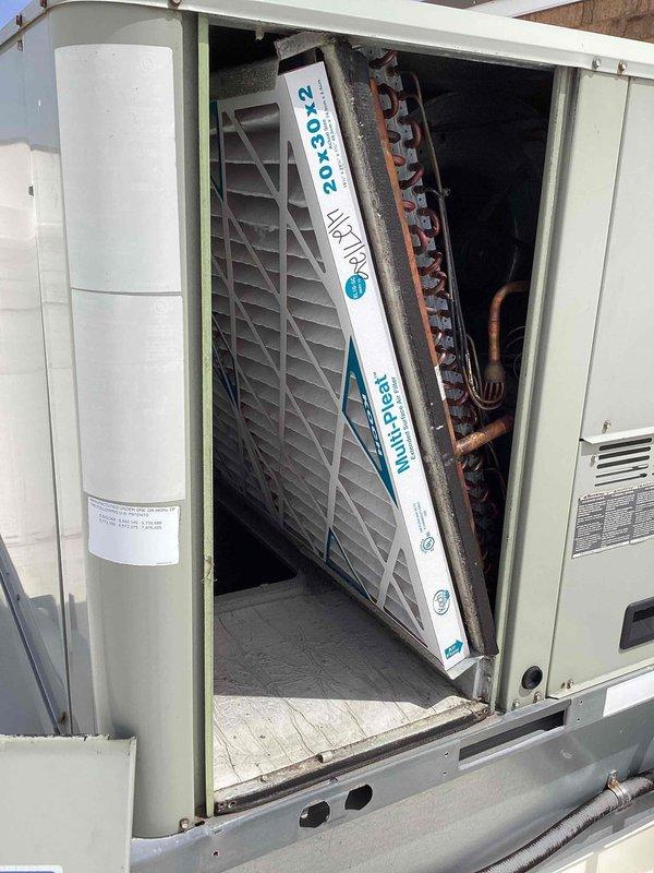 Completed scheduled commercial filter maintenance on rooftop HVAC unit. Accessed unit compartment, removed and replaced 20x20x2 MERV-rated air filter per maintenance contract specifications. Performed visual inspection of internal components including evaporator coil, refrigerant lines, and condensate drain system, noting age-appropriate oxidation on copper lines but no active leaks or operational concerns. Unit operational and secured upon completion.
