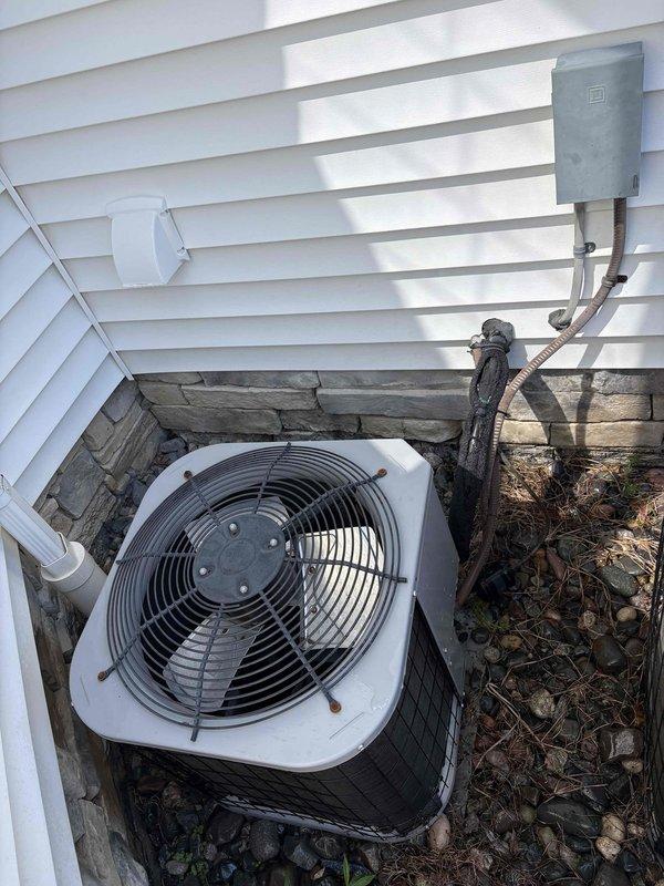 # HVAC Maintenance Summary

Completed routine preventive maintenance on residential split-system air conditioning equipment. Serviced dual outdoor condensing units located in exterior alcove area with adequate clearance for airflow and service access.

# Work Performed

Performed comprehensive cooling system inspection and maintenance on both outdoor condensing units. Conducted visual assessment of equipment condition, noting surface wear and weathering on primary unit while secondary unit showed cleaner appearance. Inspected fan assemblies and protective grilles for proper operation and structural integrity.

Examined electrical components including disconnect box and associated conduit connections. Verified proper mounting and secure installation of electrical service equipment. Checked refrigerant line insulation and flexible conduit connections for signs of deterioration or damage.

Assessed equipment installation platform constructed of composite decking material and treated lumbe