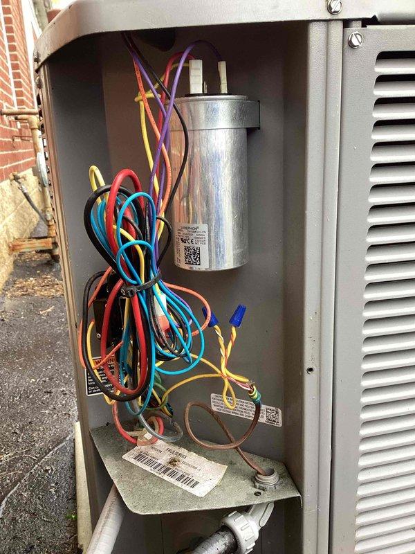 Completed spring maintenance on Armstrong commercial air conditioning unit. Removed top access panel and performed comprehensive inspection of condenser coil, compressor, capacitor, and electrical connections. All internal components found in serviceable condition with proper wiring configuration. Documented unit condition with photos showing accessible condenser coil assembly, copper refrigerant lines, and electrical control panel with capacitor and circuit board connections.