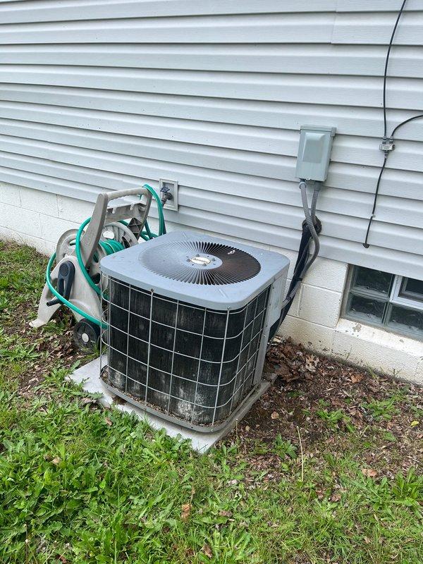 Completed AC retrofit installation at residential property. Installed new outdoor condenser unit on existing concrete pad with proper electrical disconnect and conduit routing along exterior foundation. Interior basement installation included new furnace unit with metallic supply ductwork and proper venting connections. All equipment positioned in basement mechanical room with adequate clearance from existing water heater and utilities. Electrical connections completed to code specifications, refrigerant lines properly installed and insulated, and all ductwork sealed and secured. System tested and verified operational upon completion.