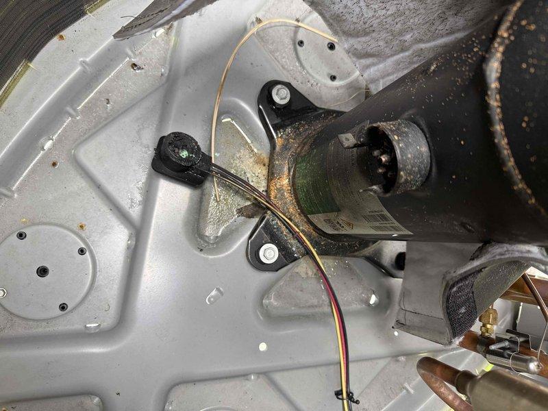 Responded to service call for non-operational air conditioning system on recent installation. Upon arrival, performed diagnostic testing using refrigerant manifold and micron gauge to assess system pressures and verify proper refrigerant charge levels. Inspected internal components including drain pump assembly and electrical connections. System pressures measured at 110.0 psig on low side and 239.9 psig on high side during testing. Verified all mechanical and electrical components were properly secured and functioning. System restored to normal operation.