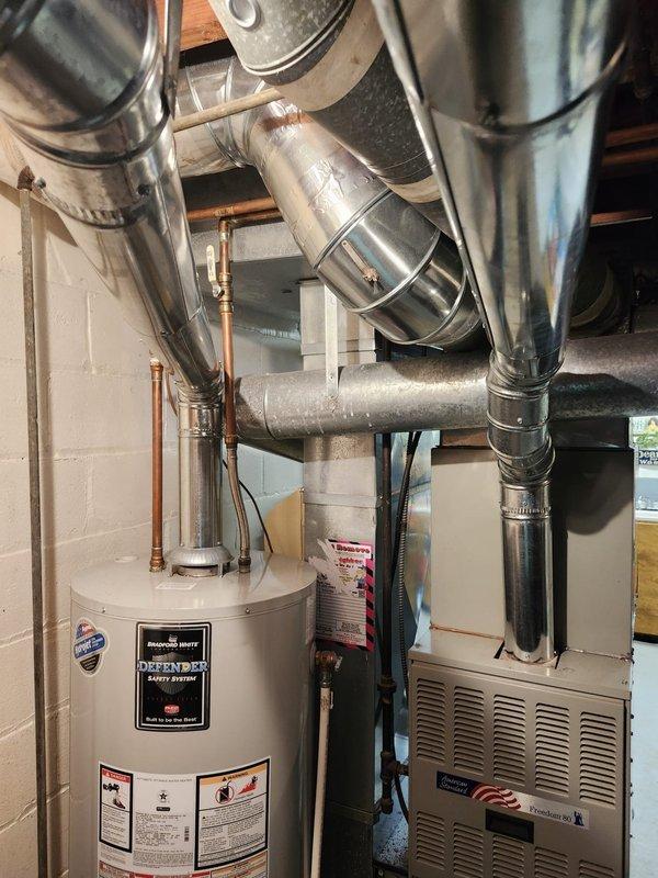 Installed new chimney liner system with two heat runs in basement mechanical room. Routed and secured metallic ductwork connecting to existing furnace unit, ensuring proper clearances from water heater and other utilities. All connections sealed and fastened per manufacturer specifications for safe operation of heating system.
