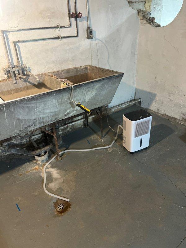 Completed comprehensive HVAC estimate for AC retrofit in residential basement utility area. Assessed existing Goodman furnace system and surrounding infrastructure, including aging copper piping, moisture management equipment, and ventilation components. Documented current equipment configuration, PVC condensate drainage system, and overall mechanical room conditions to provide accurate replacement recommendations for modernized air conditioning system integration.